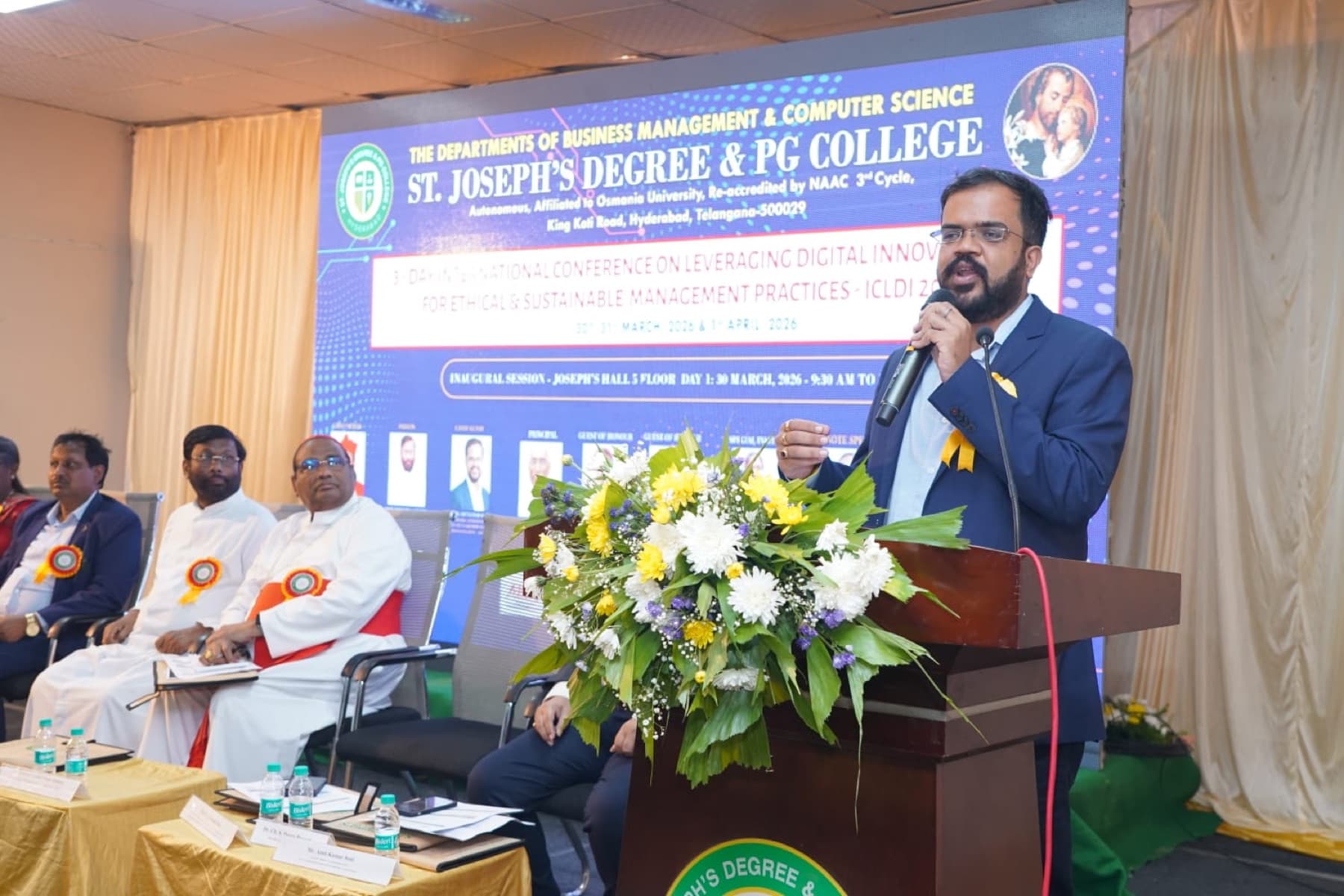 Amit Kumar Soni addressing a national conference from a podium at St. Joseph's Degree & PG College.
