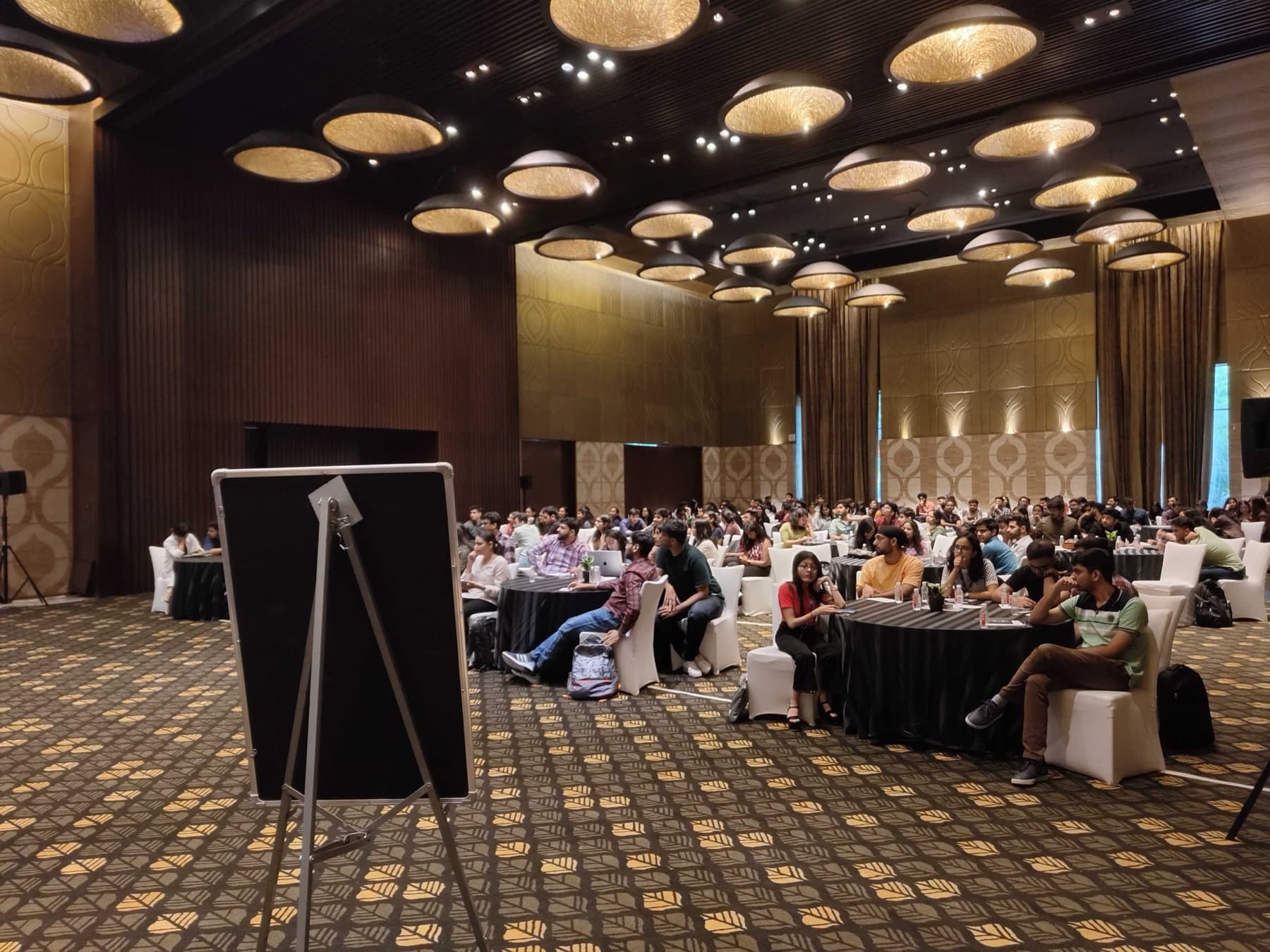 A cheerful workshop team around a long table under a Lead forward screen.