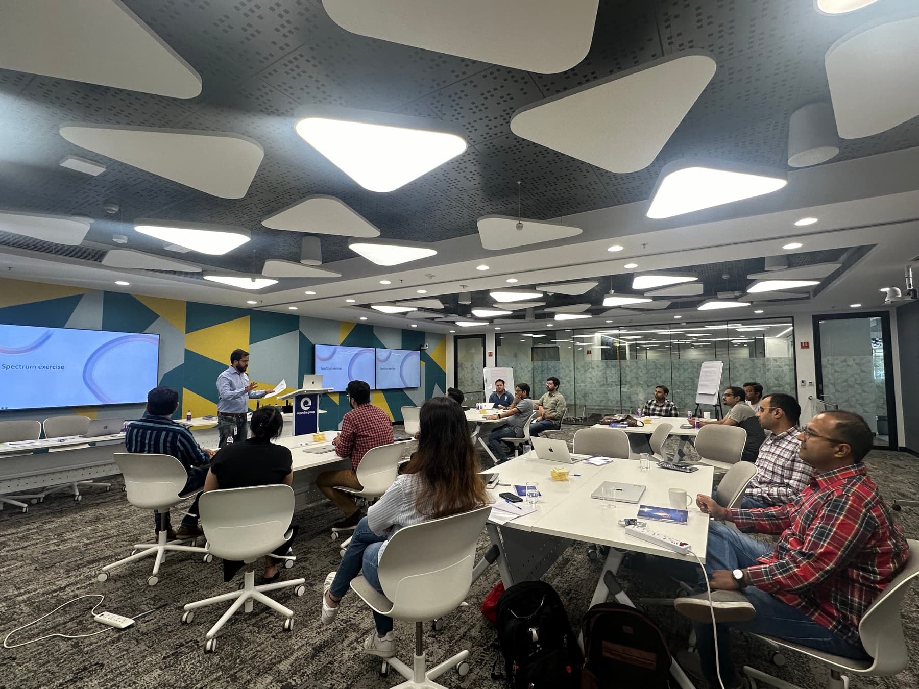 Amit Kumar Soni leading a spectrum exercise in a corporate training room.