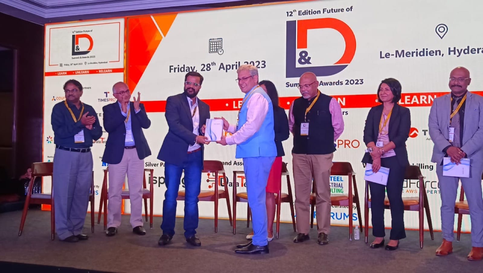 Amit Kumar Soni on stage with fellow speakers at the Future of L&D Summit and Awards.